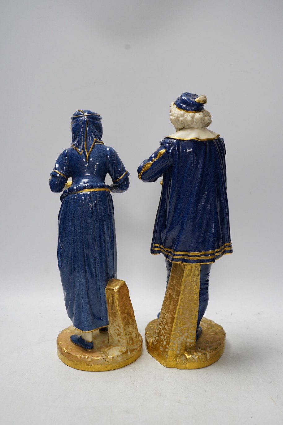 A pair of Worcester 'musician' figures by Hadley, 143 and 126, 30cm. Condition - some wear to gilding